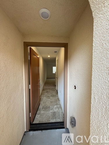 A hallway with a door at the end.