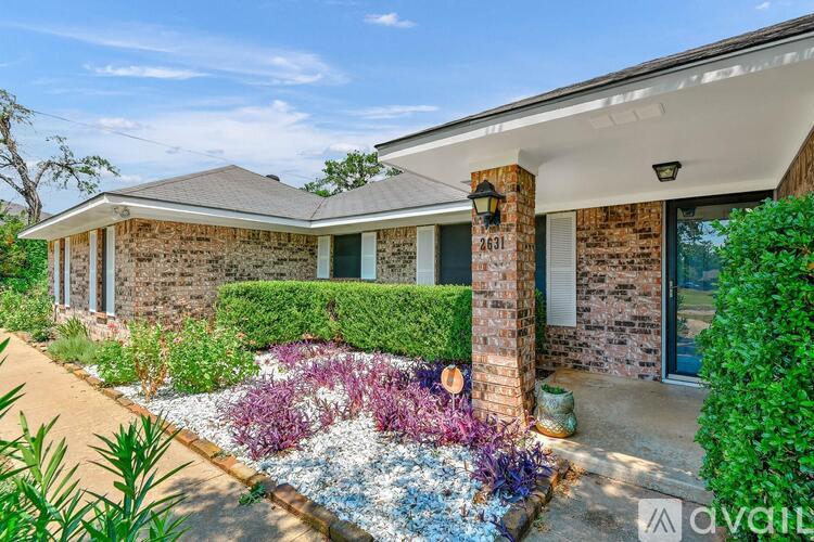 A house with a garden in front of it is for sale.