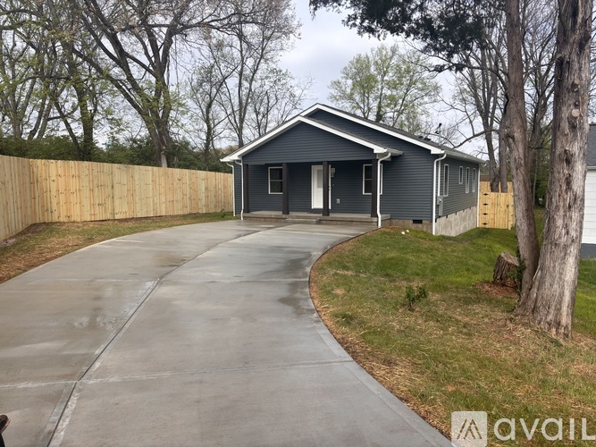 A house with a grey roof and a grey garage door is for sale.