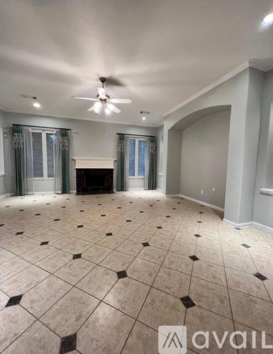 A room with a tiled floor and a ceiling fan.