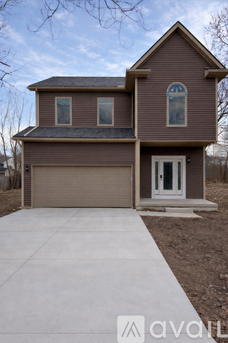 A house with a brown garage door and a white door.