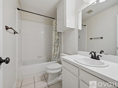 A spacious room with wooden flooring and a flat-screen TV mounted on the wall.