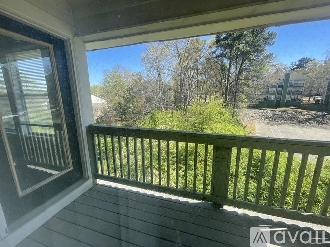 A balcony with a view of a wooded area.