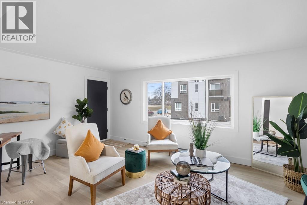 A living room with a white couch, a coffee table, and a painting on the wall.