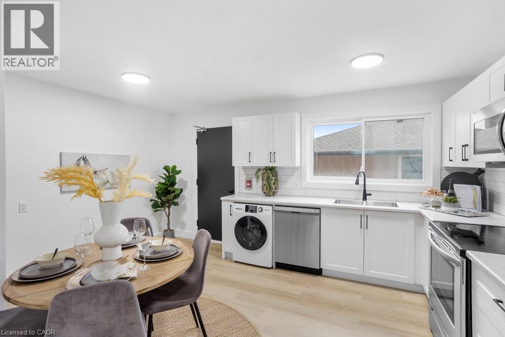 A modern kitchen with a dining table set for two.