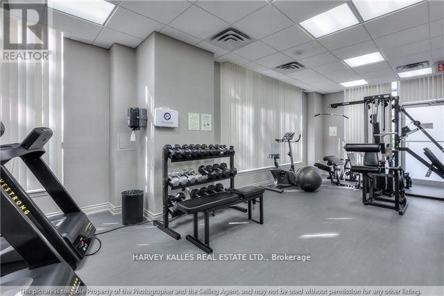 A gym with a variety of equipment including a treadmill, weights, and a bench press.