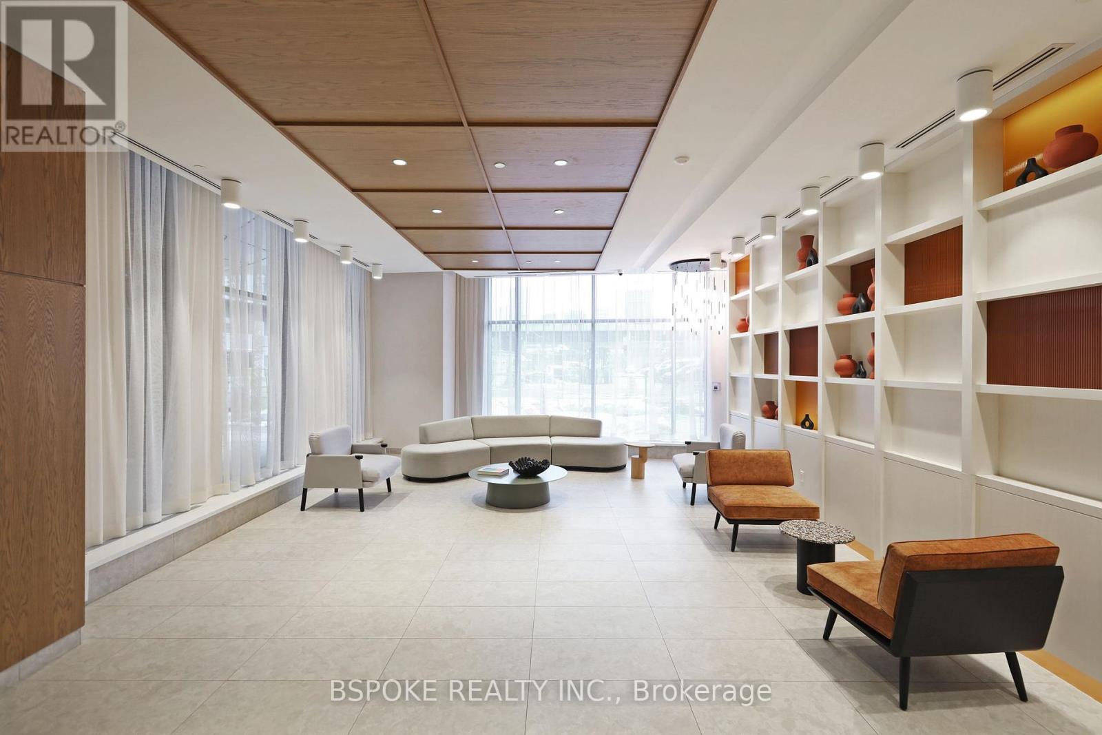 A modern living room with a long wooden shelf on the wall.