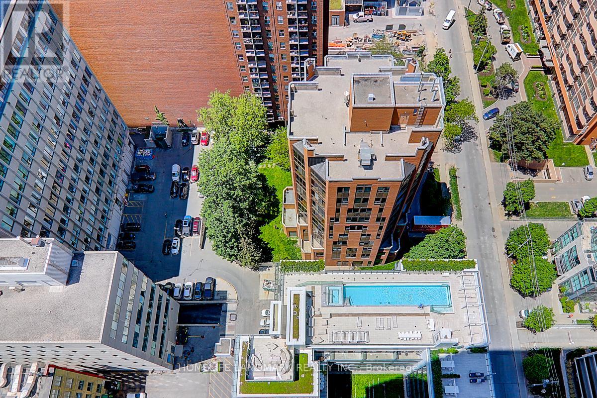 A bird's eye view of a city street with a pool and buildings.
