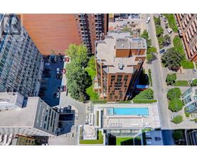 A bird's eye view of a city street with a pool and buildings.