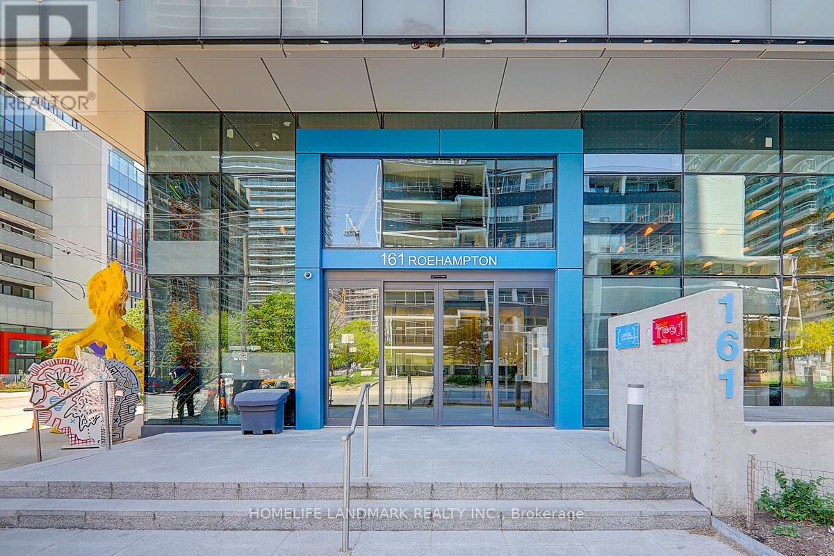 The front of a building with a blue door and a sign that says 161 O'Hampton.