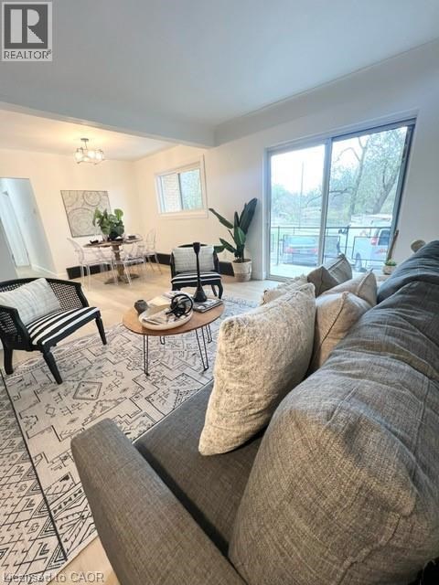 A living room with a grey sofa and a patterned rug.