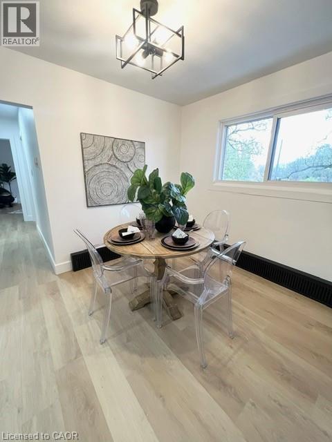 A dining room with a wooden table and chairs.