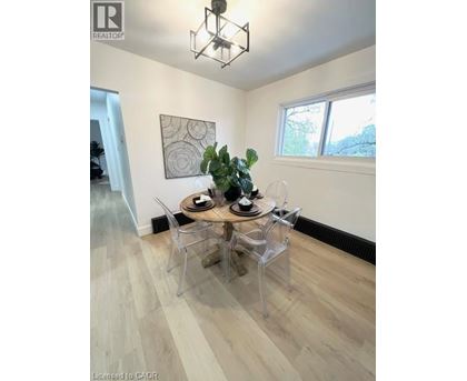 A dining room with a wooden table and chairs.
