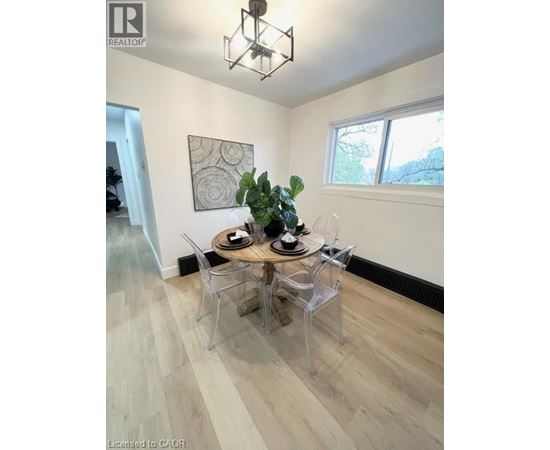 A dining room with a wooden table and chairs.