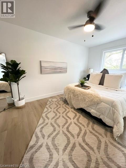 A bedroom with a large bed and a ceiling fan.