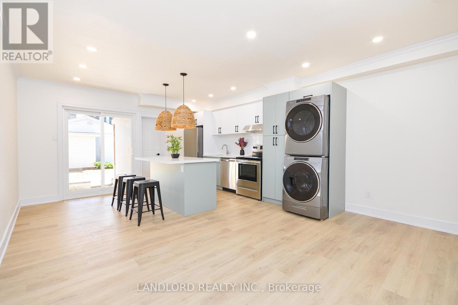 A modern kitchen with a washer and dryer built in.