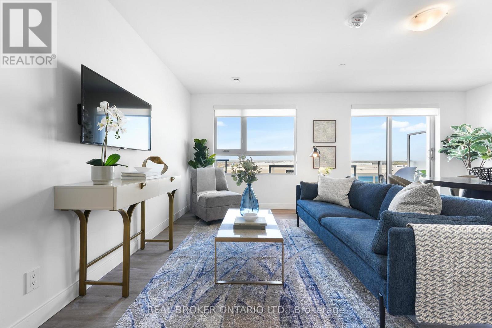 A living room with a blue couch and a coffee table.