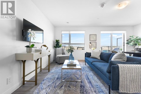 A living room with a blue couch and a coffee table.