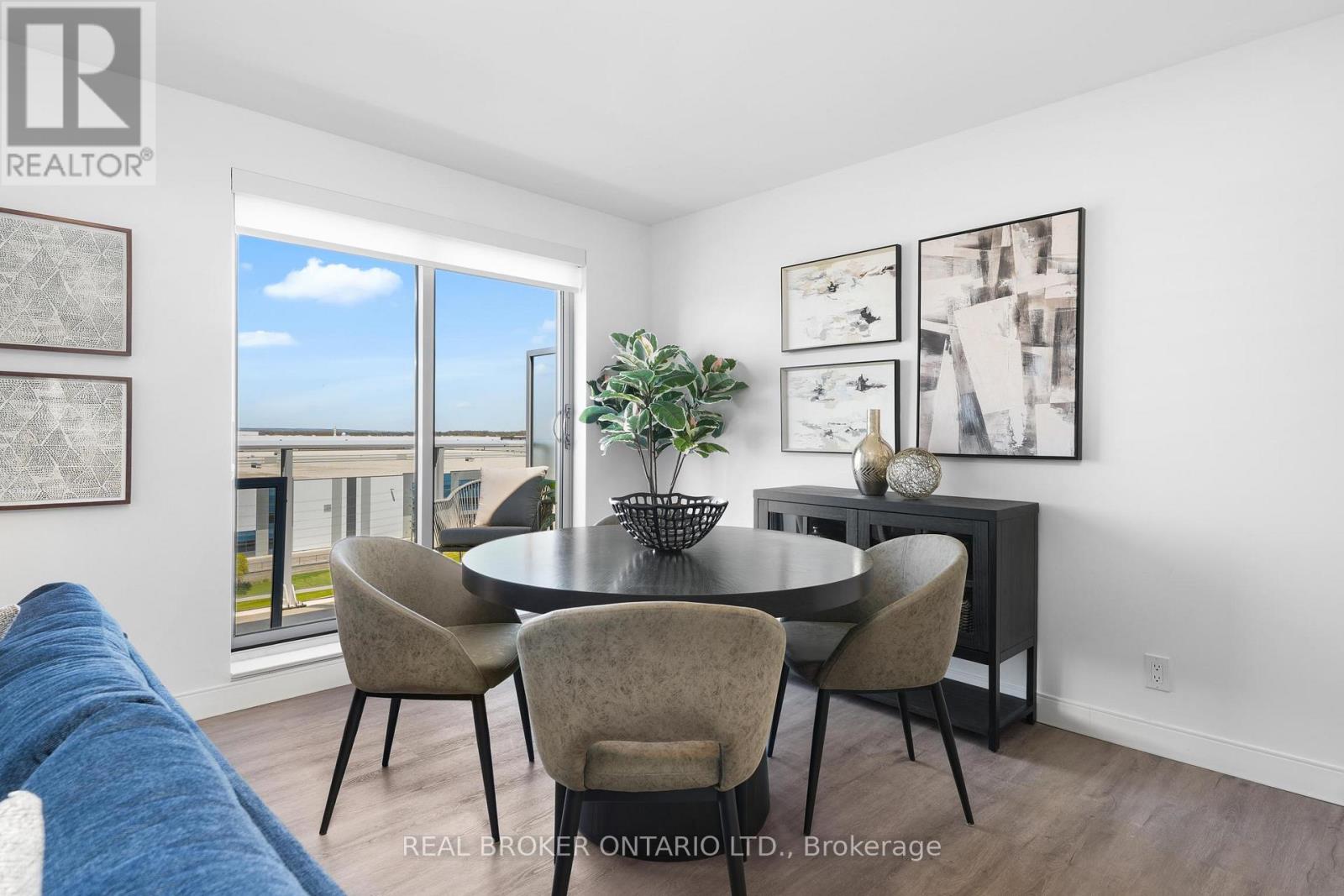 A dining room with a table and chairs and a plant on it.