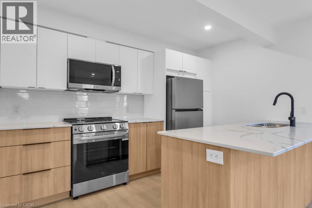 A modern kitchen with wooden cabinets and stainless steel appliances.