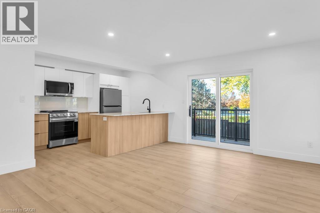 A spacious kitchen with wooden floors and a large island.