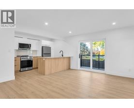 A spacious kitchen with wooden floors and a large island.