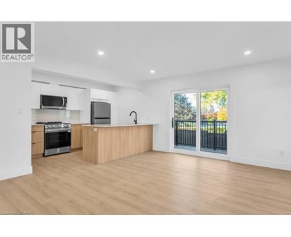 A spacious kitchen with wooden floors and a large island.