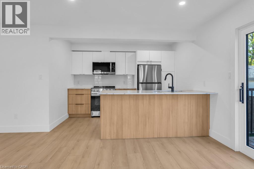 A modern kitchen with wooden cabinets and stainless steel appliances.