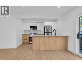 A modern kitchen with wooden cabinets and stainless steel appliances.