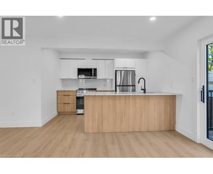 A modern kitchen with wooden cabinets and stainless steel appliances.