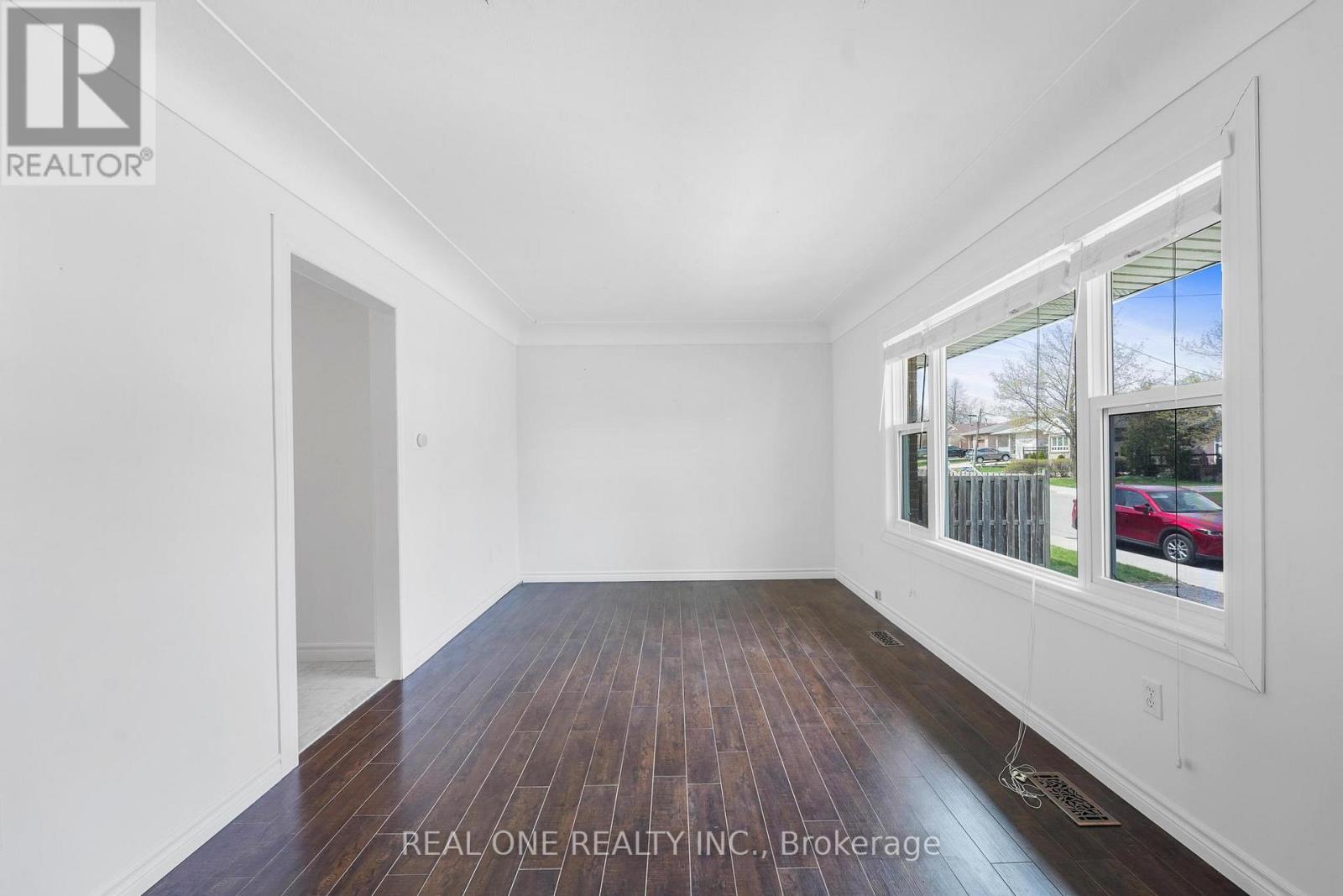 A room with white walls and a wooden floor.
