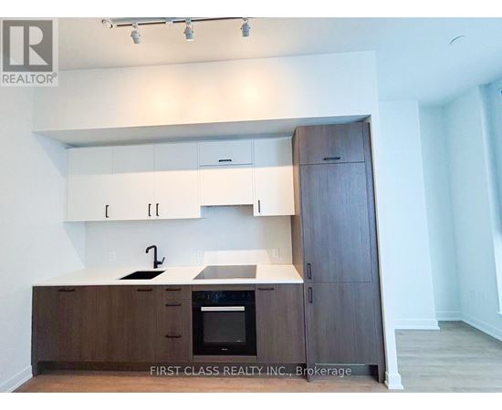 A kitchen with wooden cabinets and a black oven.