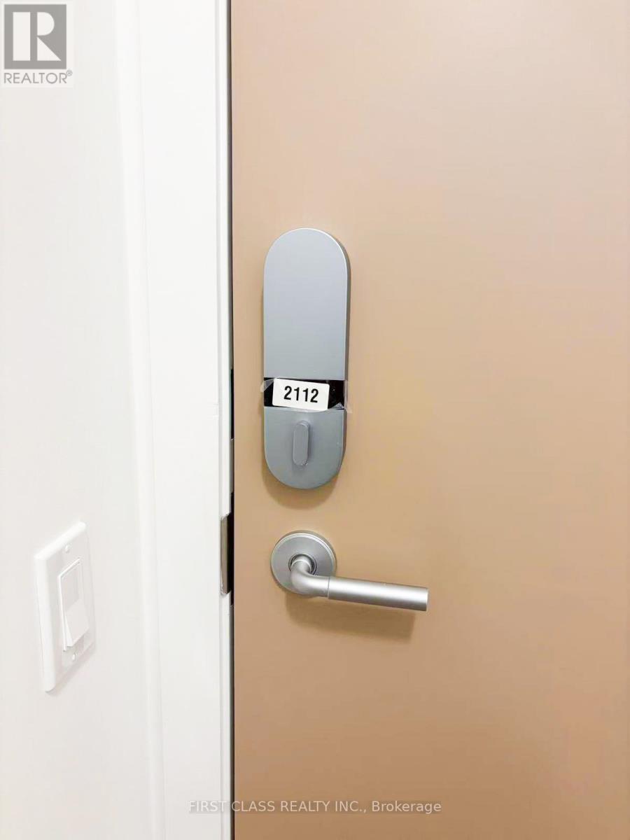 A door with a handle and a keypad on it.