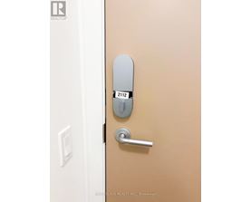 A door with a handle and a keypad on it.
