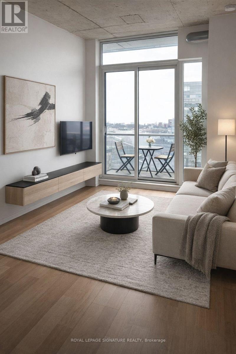 A living room with a couch, a coffee table, and a painting on the wall.