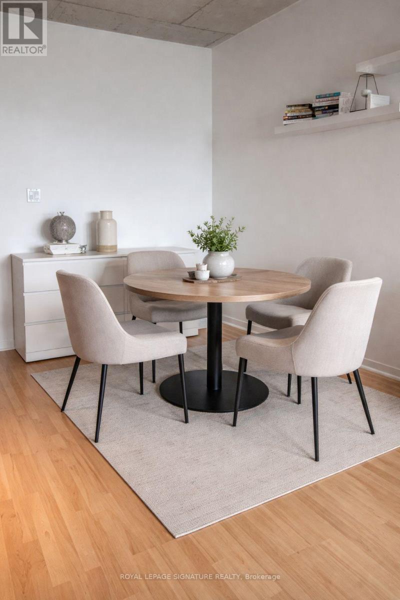 A modern dining room with a round table and chairs.