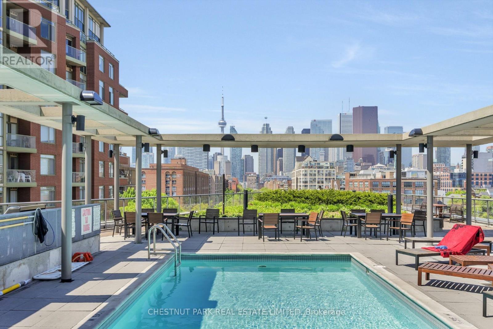 A pool on a balcony with a view of the city.