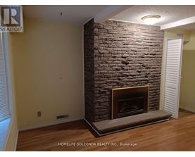 A room with a fireplace and a sign that says "REALTOR".