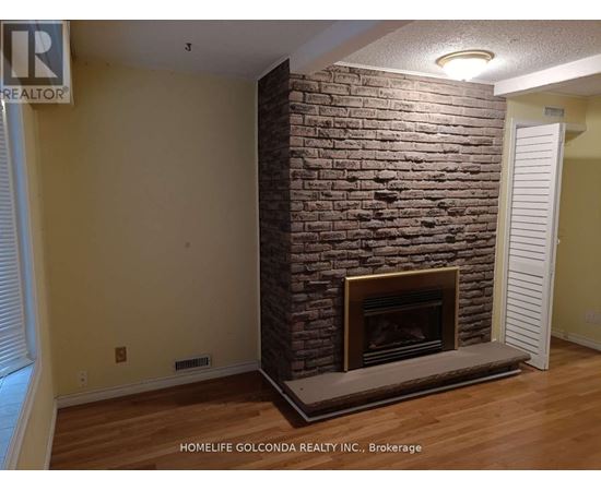 A room with a fireplace and a sign that says "REALTOR".