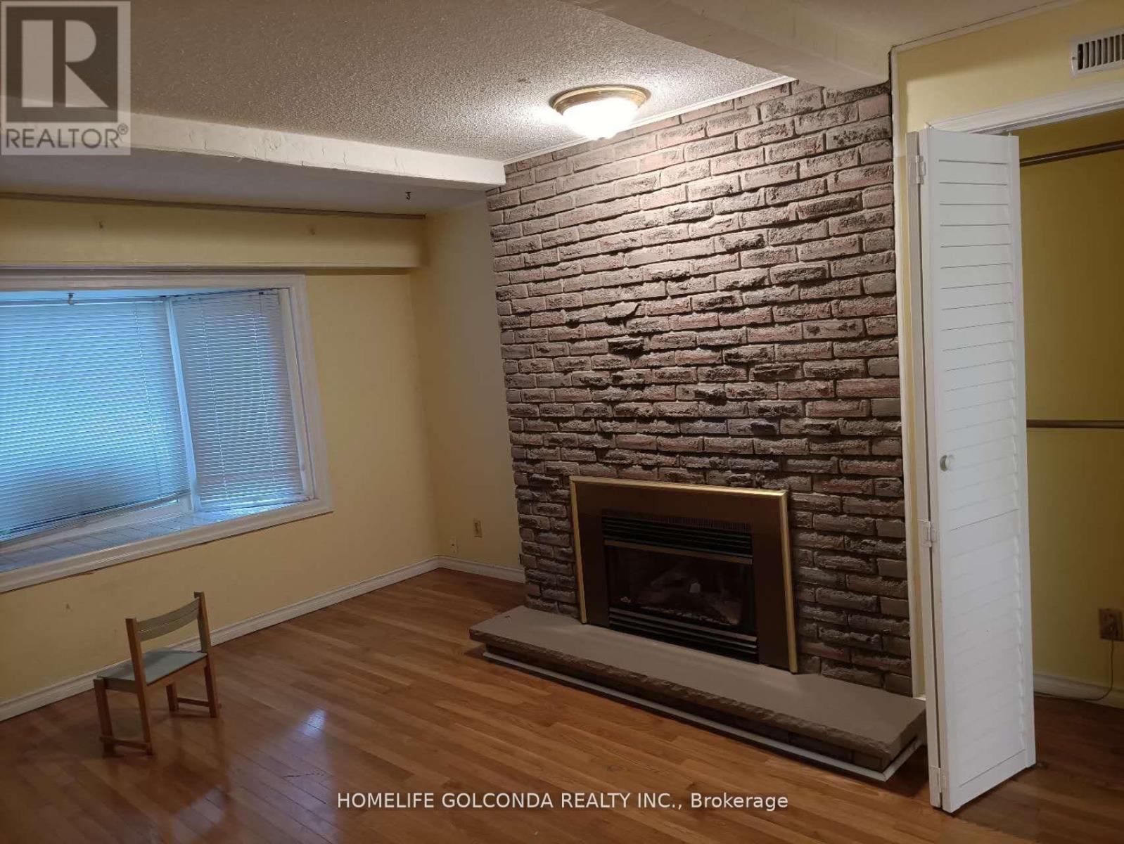 A room with a fireplace and a chair.