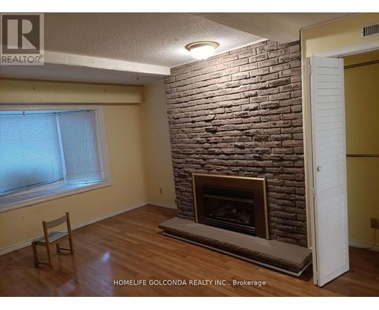 A room with a fireplace and a chair.