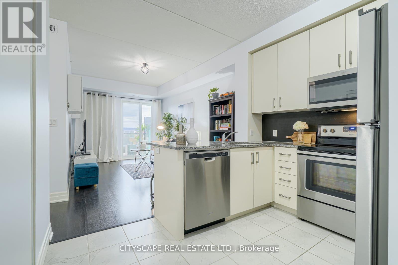 A kitchen with white cabinets and stainless steel appliances.