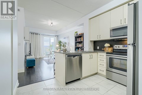 A kitchen with white cabinets and stainless steel appliances.