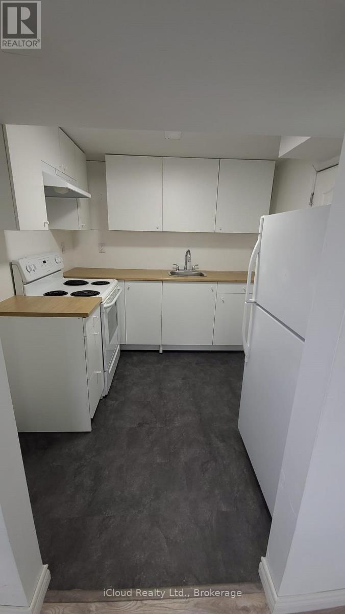 A kitchen with white appliances and cabinets.