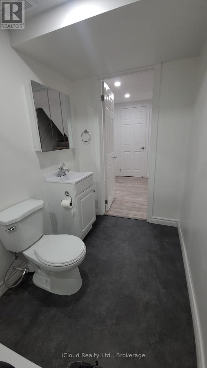 A white toilet in a small bathroom.