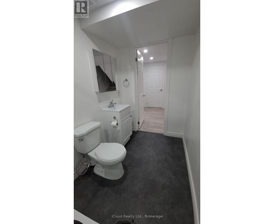 A white toilet in a small bathroom.