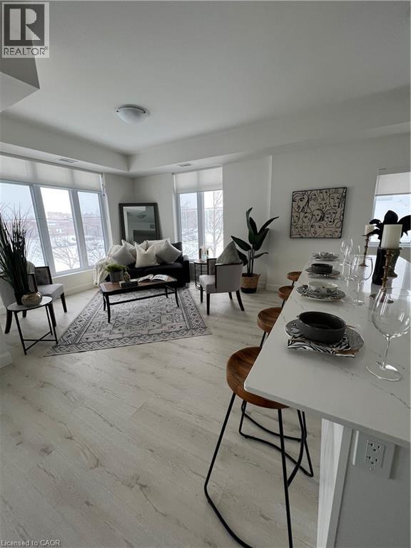 A dining room with a white table and chairs.