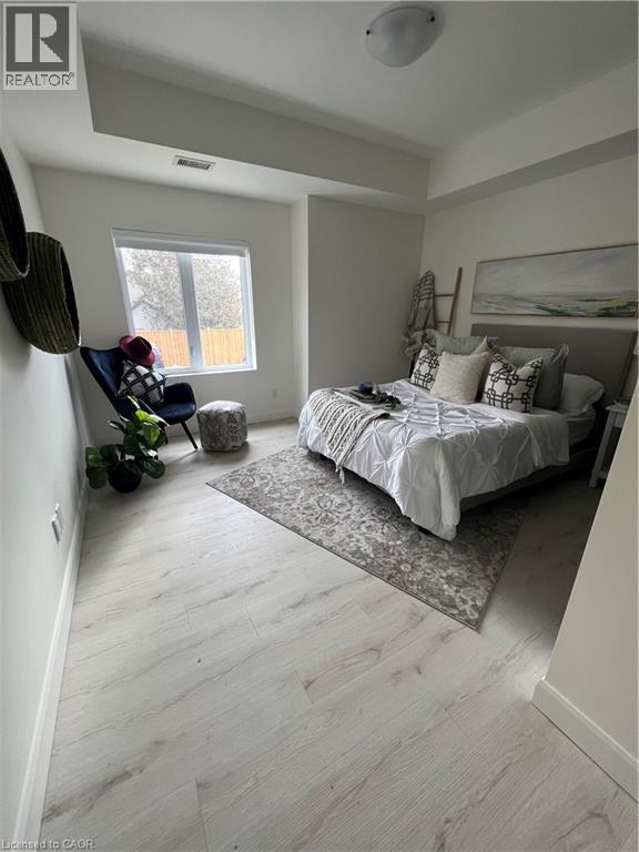 A bedroom with a large bed and a window.