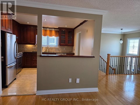 A kitchen with wooden cabinets and a refrigerator.