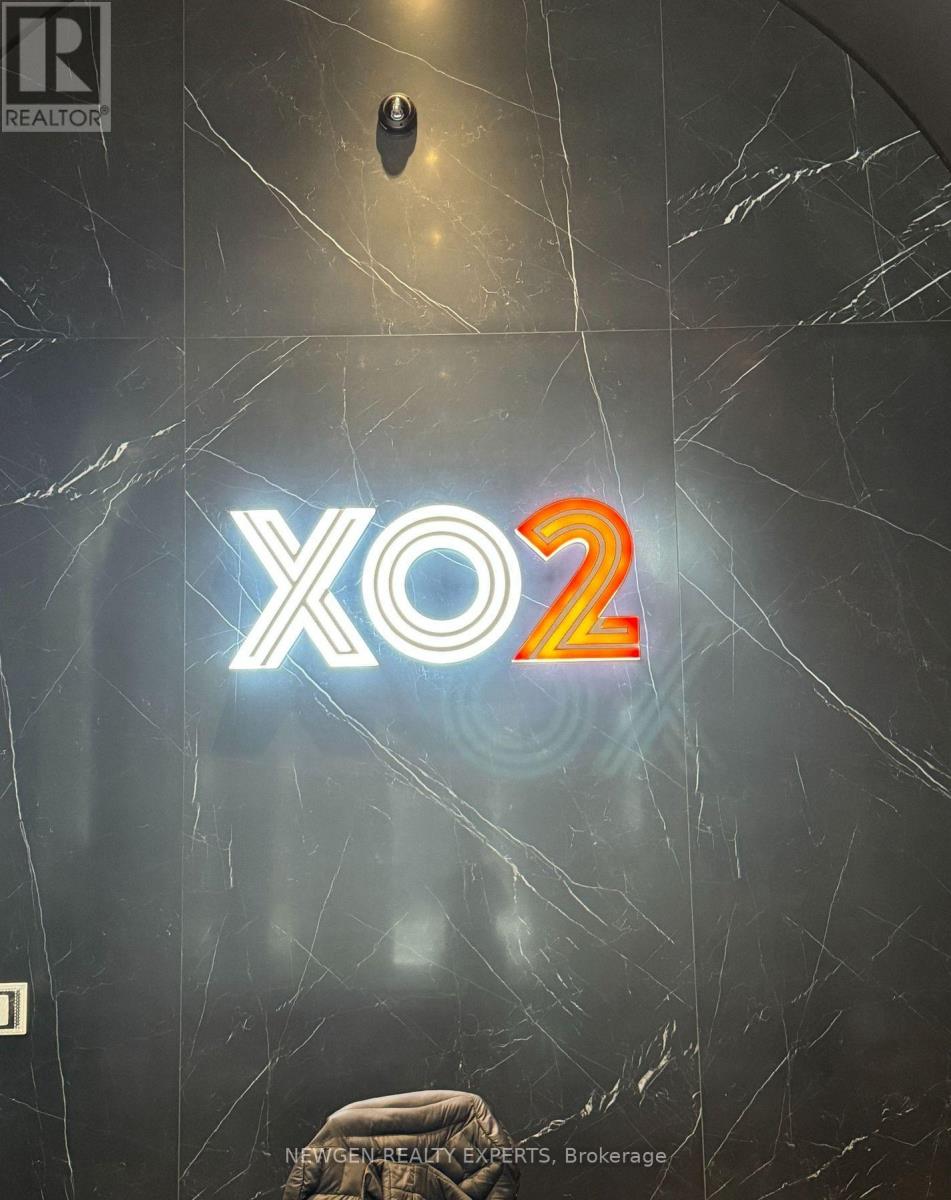 A sign with the text "XO2" in neon lights is displayed on a wall.